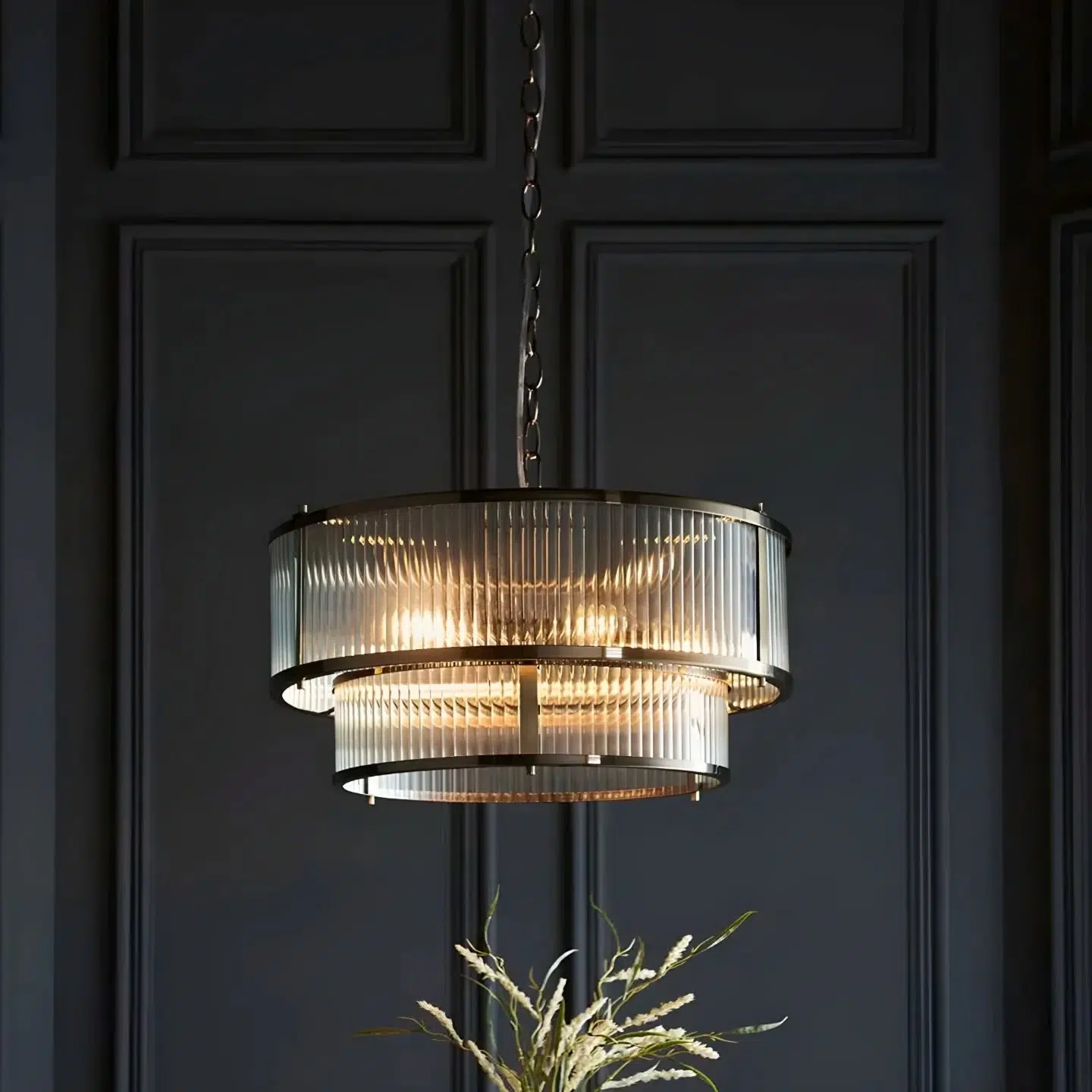 A timeless classic double tier ribbed 5 light pendant antique brass with antique brass plated metalwork, the clear ribbed glass panel shades beautifully diffuse the light. Height adjustable chain means this can be perfectly placed to illuminate hallways, living spaces or dining rooms. Matching flush light also available to create a co-ordinated look.